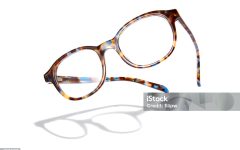 Advertising photo of flying glasses with shadow. Isolated on white background.